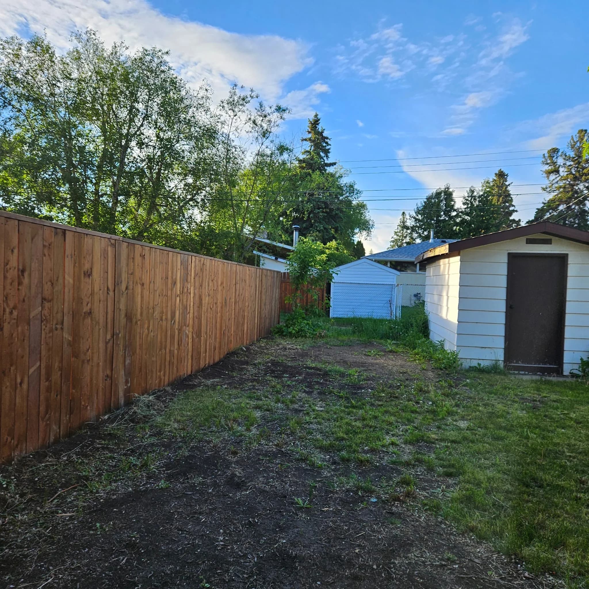Completed wood fence running along a residential property